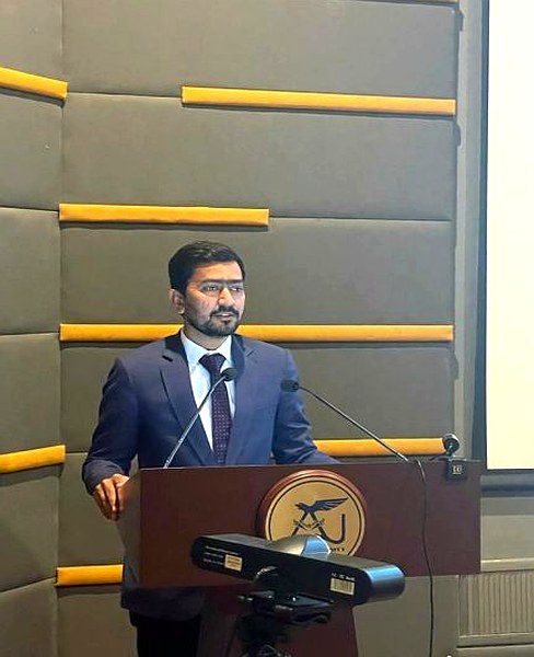Speaking at podium, IDEAS 2024 Karachi
